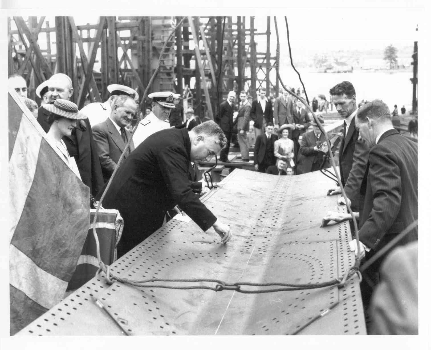 At Cockatoo Dockyard, Sydney, 16 February 1940, showing Mr. Menzies putting a rivet in the keel of ship under construction.