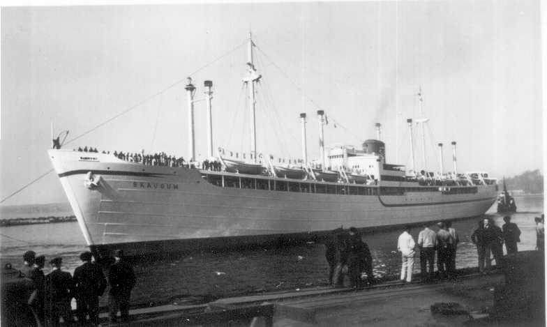 Pictured with four pairs of kingposts which were later removed during the late 1950s.  Shown entering port.