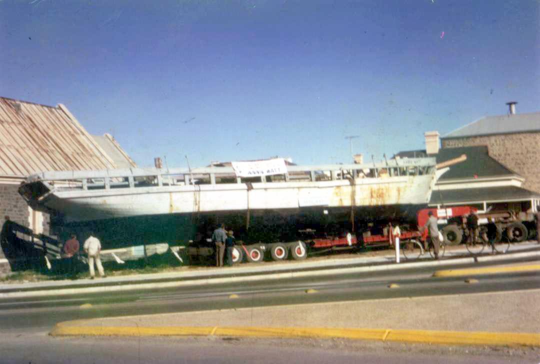 This image shows Vessel on truck trailer on the side of a road.