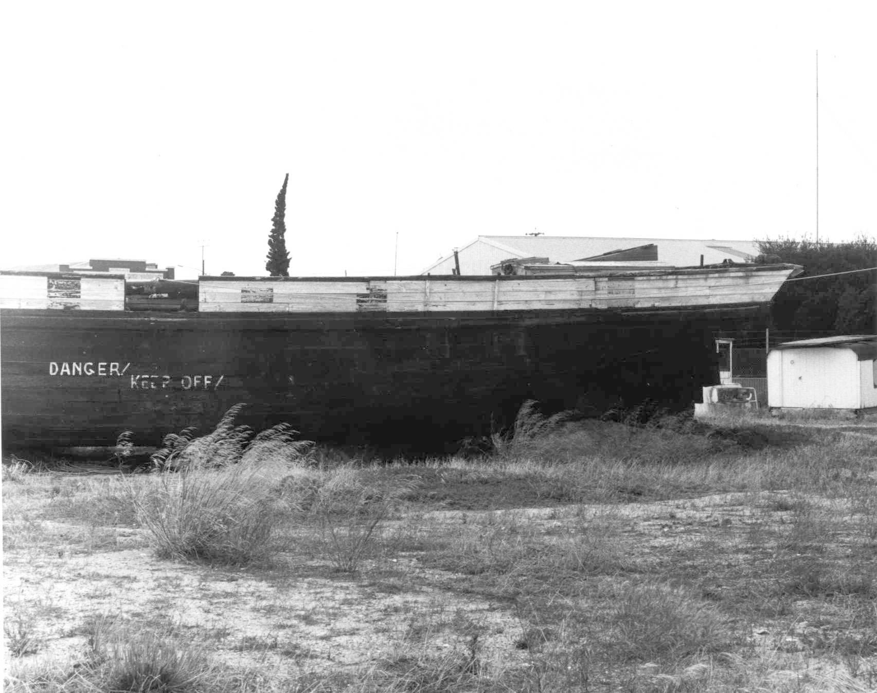  This image shows the hull of vessel on land, reading DANGER, KEEP OFF.