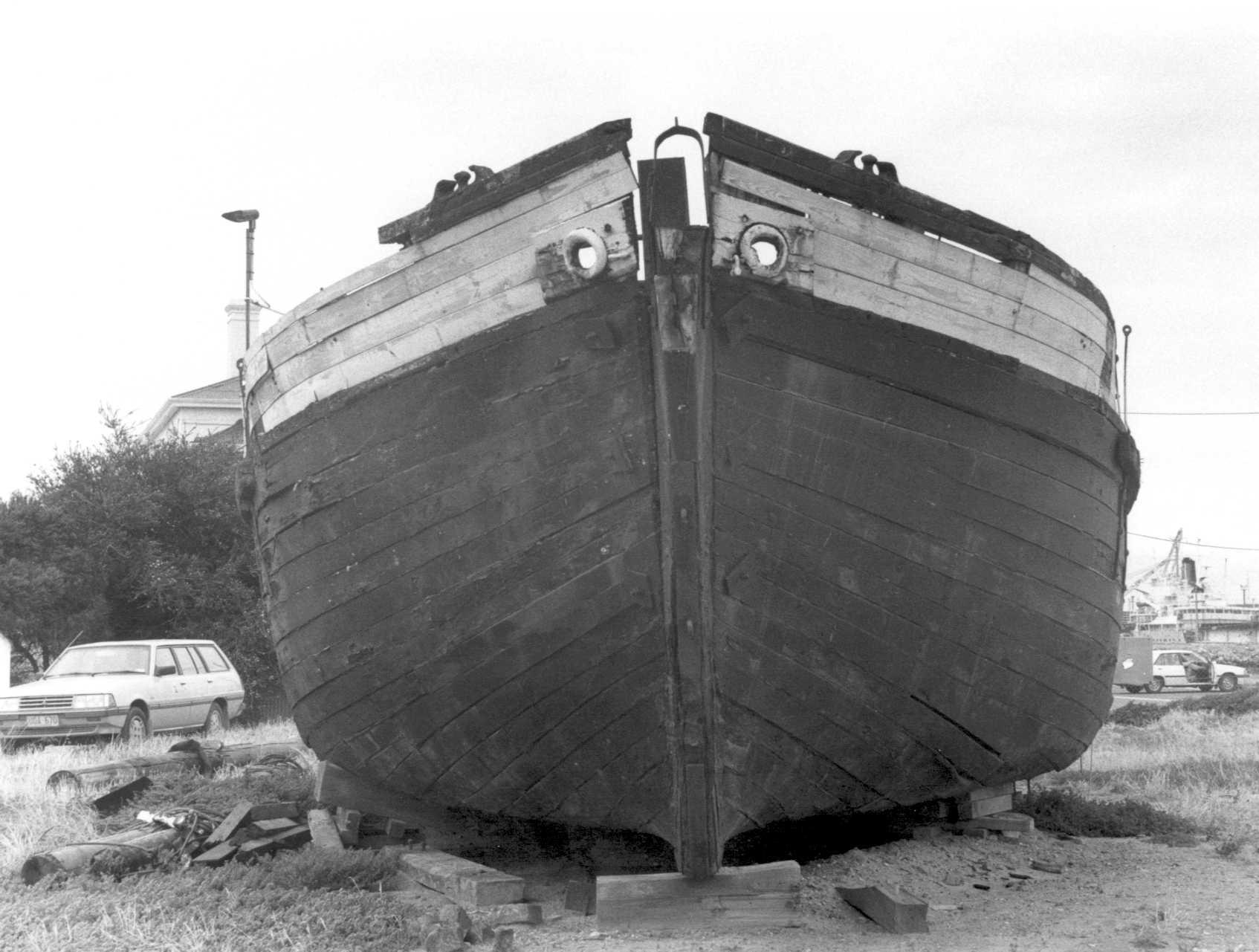 This image shows bow of vessel, on land, in a state of disrepair.
