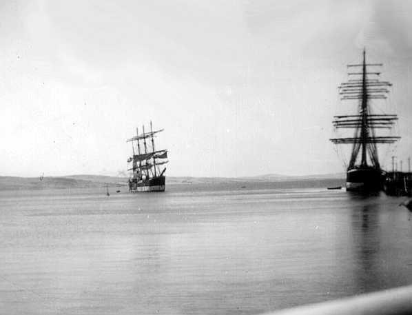 This image shows vessels at Port Lincoln, SA.  "Lawhill" beside the jetty and "Pamir" further out, January 1937.