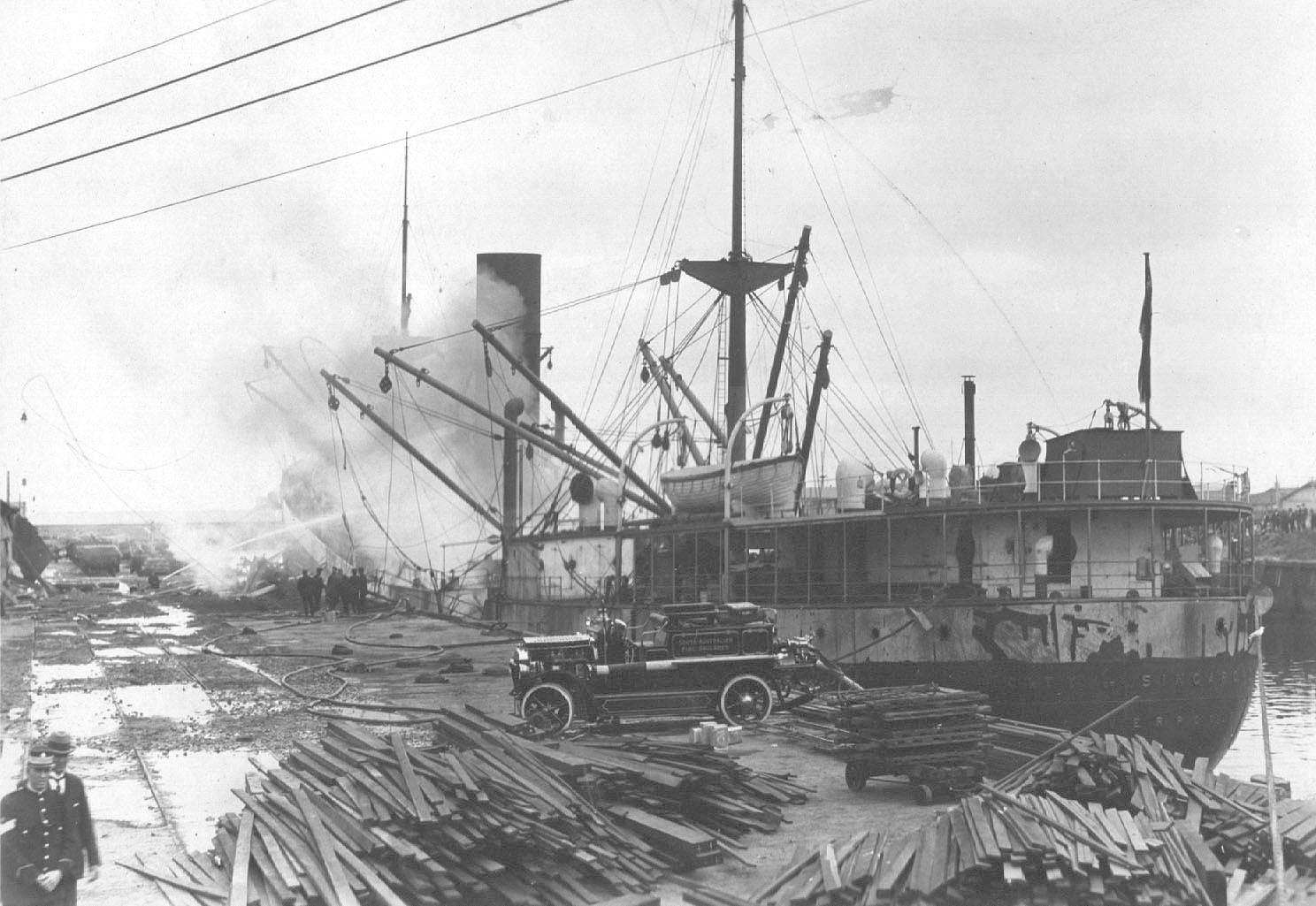 General cargo vessel "City Of Singapore", built in 1923 at west Hartelpool by Wm Gray & Co for Ellerman Lines Ltd.  On 26 - 4 - 1924 at 10pm the tragic scene at No 2 Quay, Port Adelaide, where the petrol laden "City Of singapore" exploded.  Explosives abo