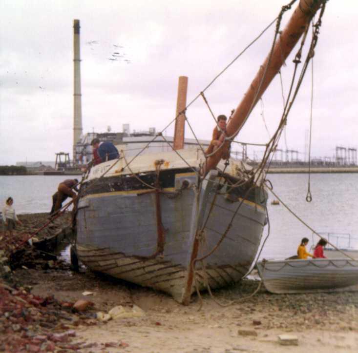 This image shows the bow of vessel, on land, in a state of disrepair.