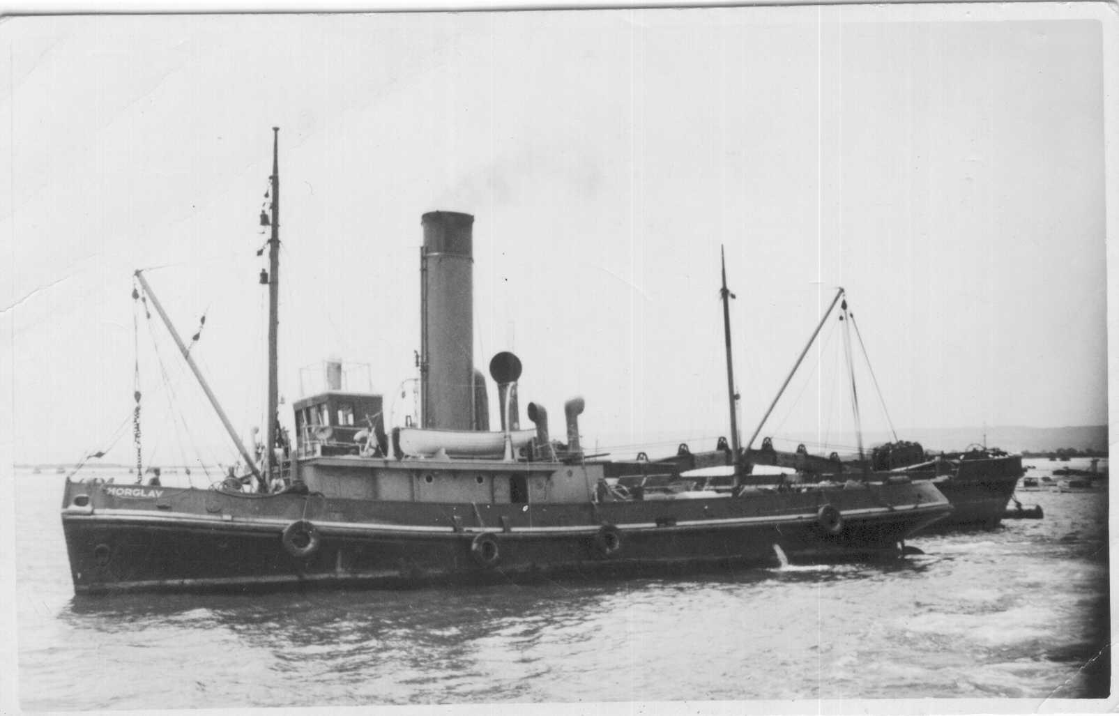 Tug towing dredge