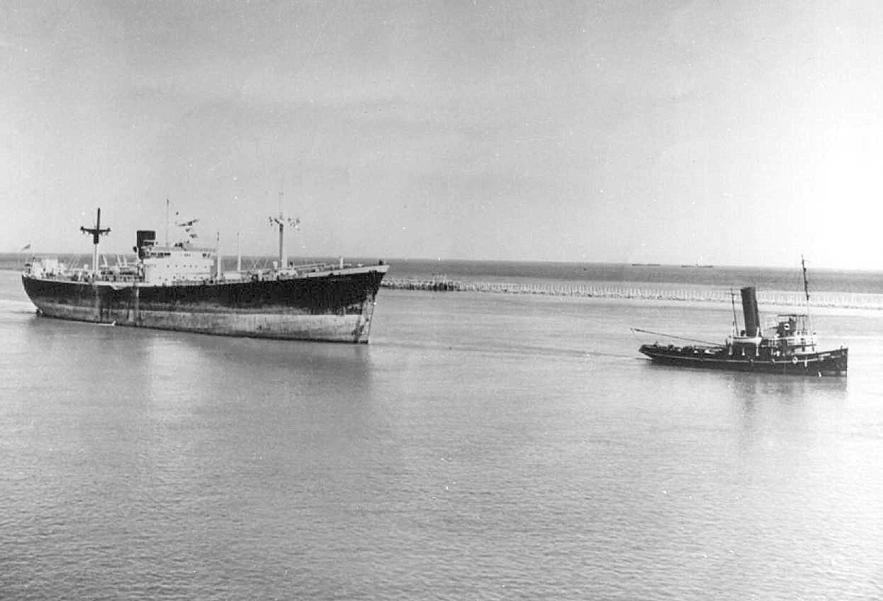 Tug with steamer in tow