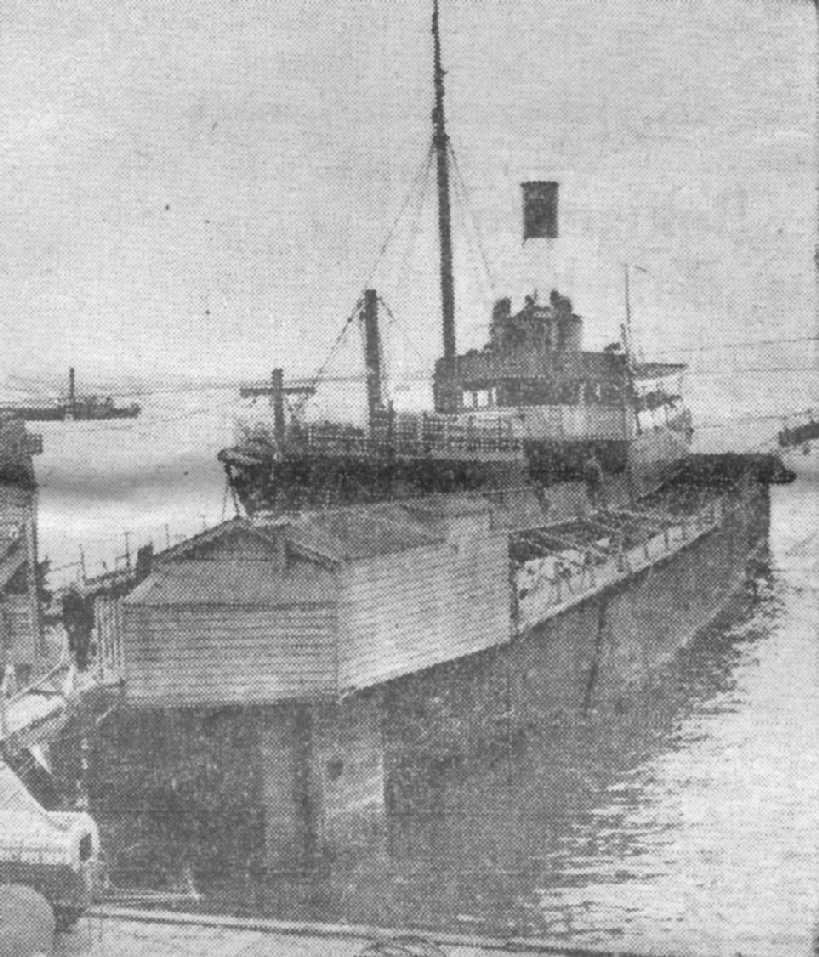 1854 passenger cargo vessel at a floating dock