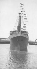 1909 passenger vessel.
This image shows vessel leaving Port Adelaide under tow from tug S.S. Falcon and with flags flying.
