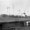 Pictured with four pairs of kingposts which were later removed during the late 1950s.  Shown entering port.