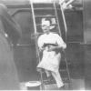Ship's Cook holding cat on board ship at McLaren Wharf, Port Adelaide, 8 April, 1931
