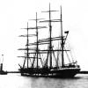 1882 barque, under tow.