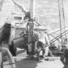Ketch, crew on deck at sea.