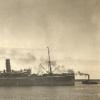 Image: large steamship with tug boats in water